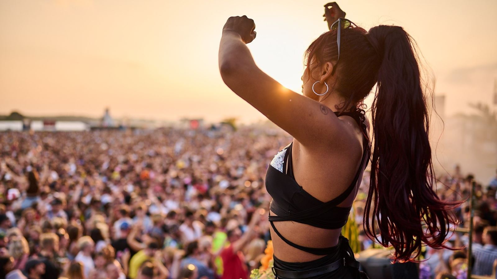 A dancer at Love Saves the Day festival with the crowd in the background CREDIT Julian Preece